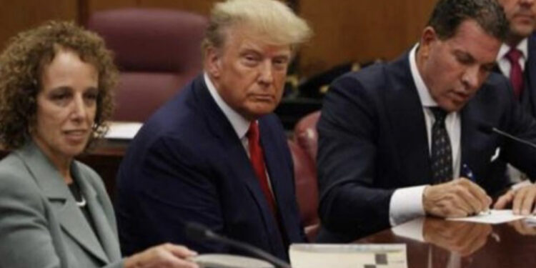 Duart poshtë tavolinës, a është i prangosur? Del FOTO e Donald Trump në sallën e gjyqit