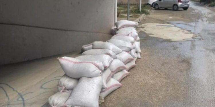 FOTO/ Parashikimet për mot të keq, qytetarët e Vlorës i paraprijnë përmbytjeve, vendosin thasë me rërë para bizneseve dhe banesave