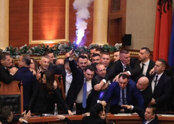 FOTOT/ Tensione dhe përplasje në Kuvend, deputetët e PD sjellin flakadanët në sallë. Çfarë nuk u pa gjatë seancës parlamentare.